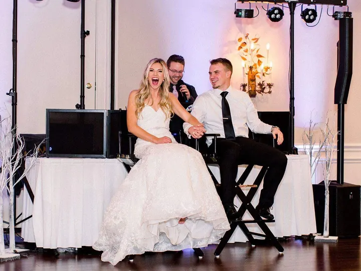 Bride and groom seated in front of their wedding DJ